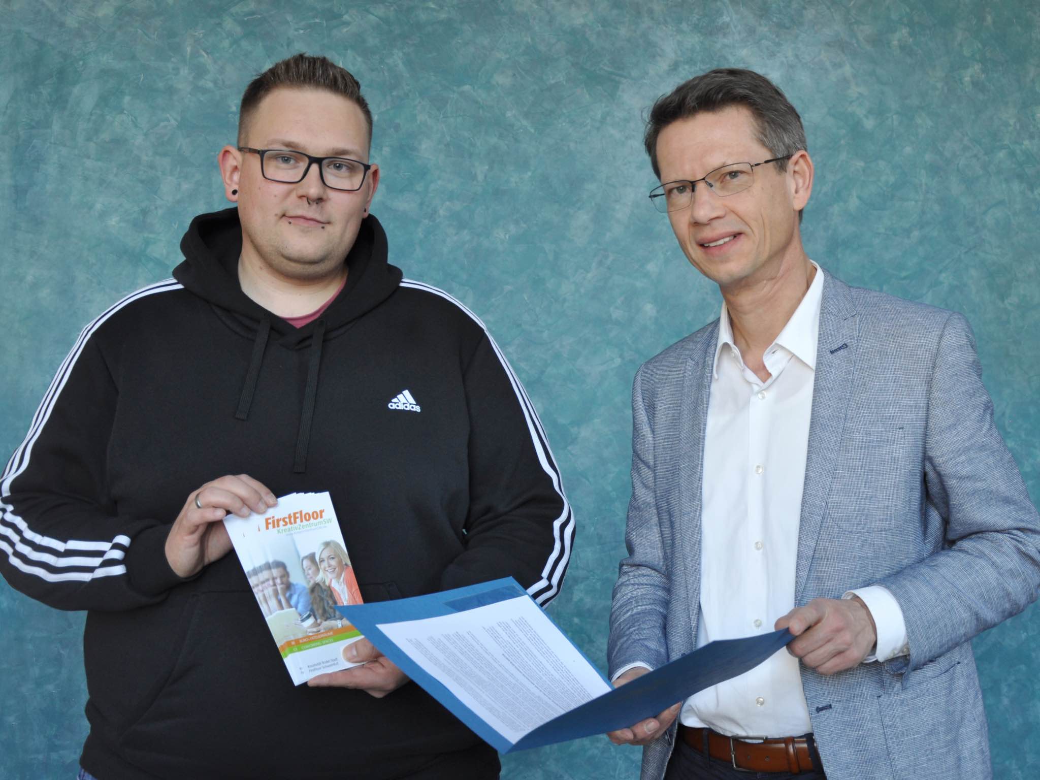 Mietvertragsuebergabe_First-Floor Oberbürgermeister Sebastian Remelé (rechts) übergibt Sandro Mühlbauer (links) den Mietvertrag. Foto: Marina Euler, Stadt Schweinfurt.
